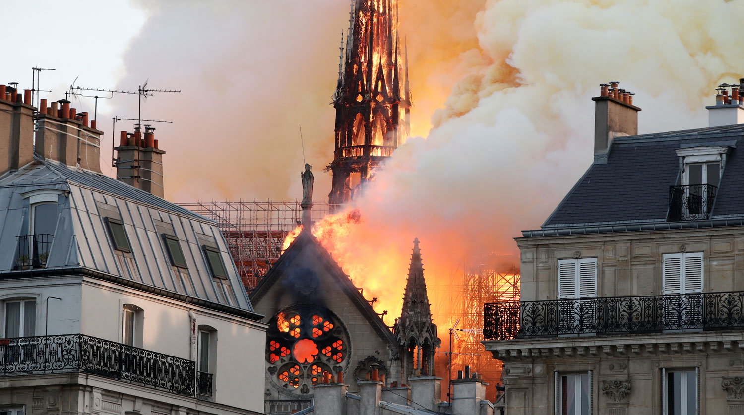 Smoke billows as fire engulfs the spire of Notre Dame Cathedral in Paris, France April 15, 2019. REUTERS/Benoit Tessier - RC19CF540000